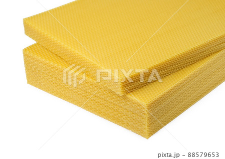 Beeswax. Wax base for honey bee rebuilding on a white background. Honeycombs. 88579653