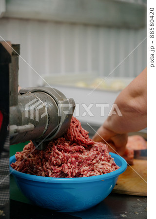 Raw meat. The process of preparing forcemeat by means of a meat grinder. 88580420