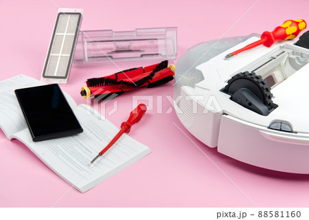white robot vacuum cleaner. Vacuum cleaner robot repair concept on pink background. technology robot 88581160