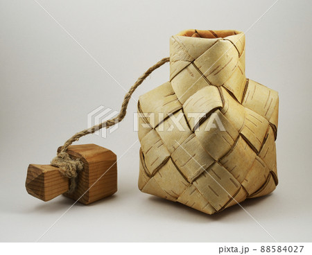 a traditional salt container woven from birch bark with a wooden lid 88584027