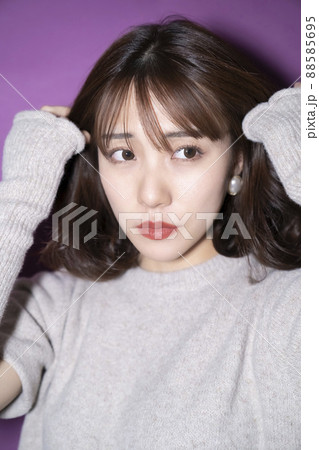 紫バック　髪の毛を耳にかける女性 88585695