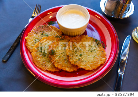 Belarusian traditional potato pancakes with sour cream Belarusian traditional potato pancakes with sour cream 88587894