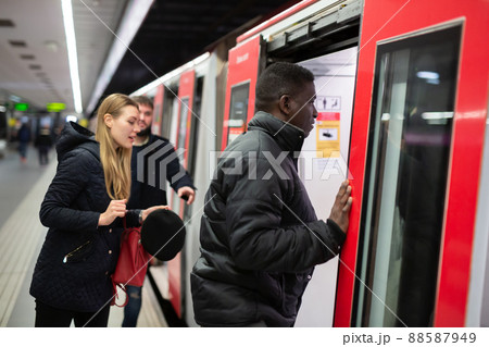 African man getting on subway car African man getting on subway car 88587949