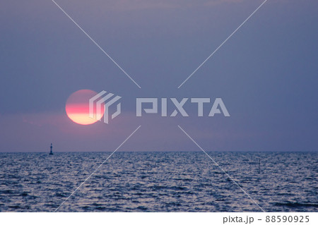 The landscape on a clear sky day will see a beautiful sunset slowly sliding down above the sea surface. It's a beautiful sight to see. 88590925