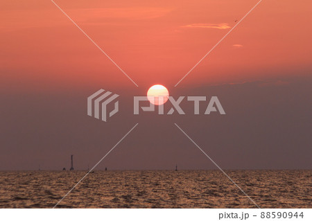 The landscape on a clear sky day will see a beautiful sunset slowly sliding down above the sea surface. It's a beautiful sight to see. 88590944