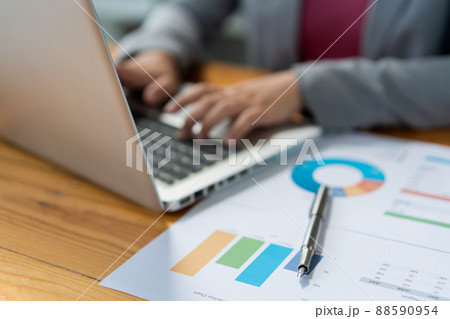 Business analyst concept the female officer typing financial information on the computer laptop Business analyst concept the female officer typing financial information on the computer laptop 88590954