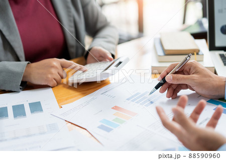 Business negotiation concept the female broker estimating the number of estate and checking it with the male broker 88590960