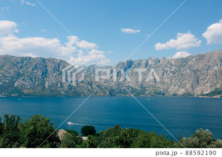 Motor boat sails through the turquoise waters of the Bay of Kotor Motor boat sails through the turquoise waters of the Bay of Kotor 88592190