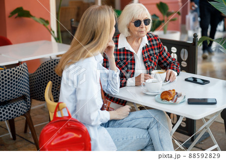 Elderly lady with young woman in cafe Elderly lady with young woman in cafe 88592829