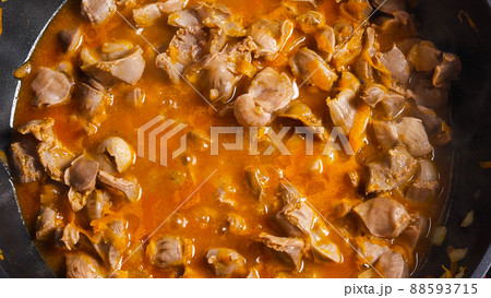 A top view of the wok with cooking chicken offal. Close-up. Asian-style cooking. A top view of the wok with cooking chicken offal. Close-up. Asian-style cooking. 88593715