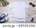 Womens white T-shirt mockup with burdock flowers 88595498