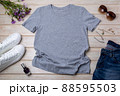 Womens gray T-shirt mockup with burdock flowers 88595503
