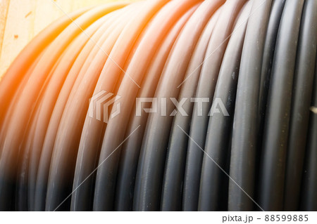 New black power cable is wound on wooden coil. Background. Cable for laying underground. New black power cable is wound on wooden coil. Background. Cable for laying underground. 88599885