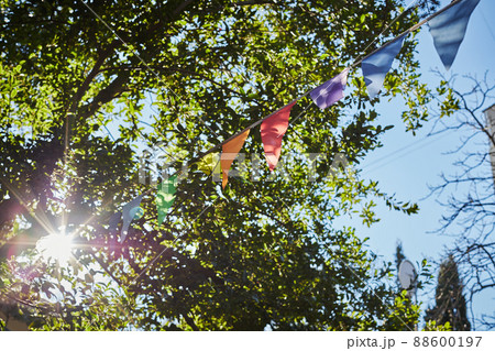 Festive fabric garlands against the blue sky in summer. The concept of celebration, rest, joy and happiness. Front view. Festive fabric garlands against the blue sky in summer. The concept of celebration, rest, joy and happiness. Front view. 88600197