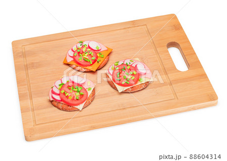 Crispy Cracker Sandwiches with Tomato, Sausage, Cheese, Green Onions and Radish - Isolated Crispy Cracker Sandwiches with Tomato, Sausage, Cheese, Green Onions and Radish - Isolated 88604314