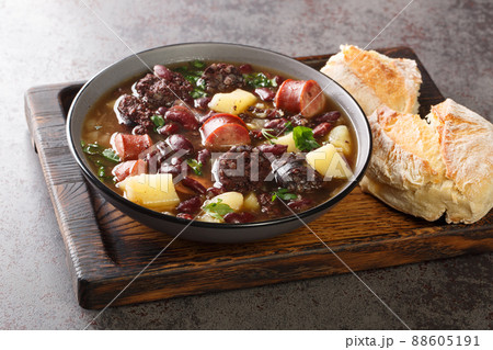 Stone soup of red beans, potatoes, chorizo, black pudding close-up in a bowl. horizontal 88605191