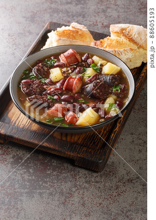 Sopa da Pedra Portuguese Stone Soup closeup in the plate. Vertical 88605193