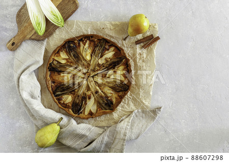 Homemade endive, pear and gorgonzola tart, flatlay, copy space 88607298