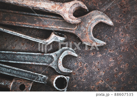 Old wrenches tools on rusty metal table 88607535