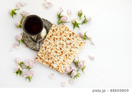Pesah celebration concept, jewish Passover holiday. Matzah and red kosher. Traditional ritual Jewish bread on white background 88609809