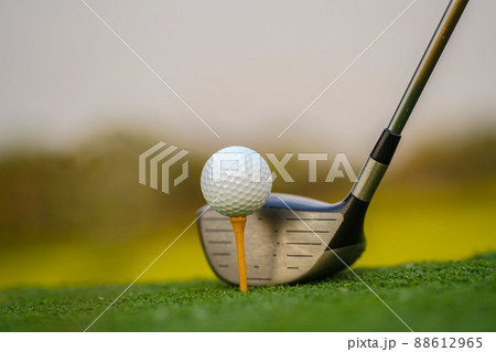 Golf club and ball on green grass ready to be struck on golf course background Golf club and ball on green grass ready to be struck on golf course background 88612965