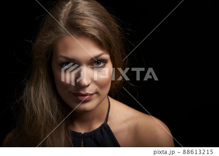 Closeup of young beautiful woman over black background 88613215