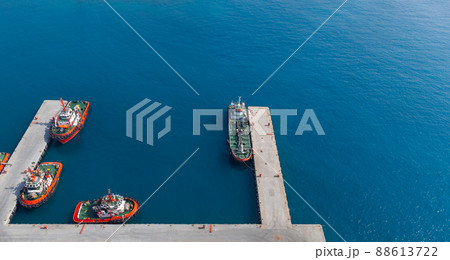Tug boats and tanker vessel are moored in port. Aerial view. Jedda port 88613722