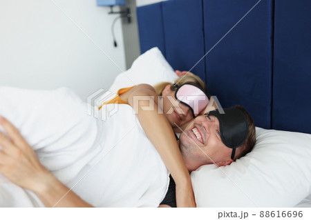 Smiling man and woman are sleeping in bed Smiling man and woman are sleeping in bed 88616696