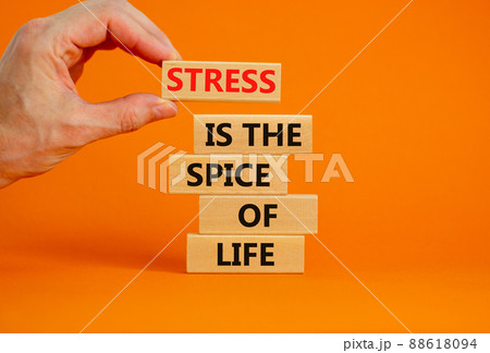 Stress spice of life symbol. Concept words Stress is the spice of life on wooden blocks. Businessman hand. Beautiful orange background. Business motivational stress spice of life concept. Copy space. 88618094