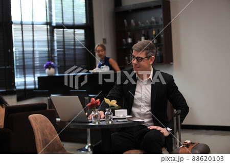 businessman checking a travelling passport. passengers in lounge International airports. exclusive room businessman checking a travelling passport. passengers in lounge International airports. exclusive room 88620103