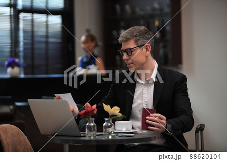 businessman checking a travelling passport. passengers in lounge International airports. exclusive room businessman checking a travelling passport. passengers in lounge International airports. exclusive room 88620104