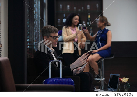 businessman checking a travelling passport. passengers in lounge  International airports. exclusive room 88620106