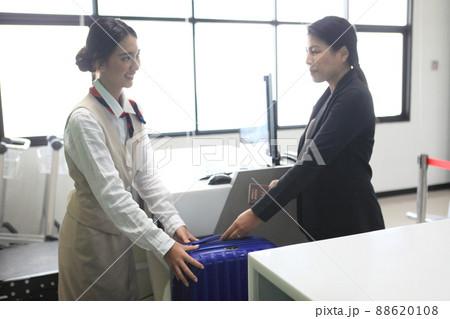 checking bag airport , Luggage weighting at check-in desk at Asia airport checking bag airport , Luggage weighting at check-in desk at Asia airport 88620108