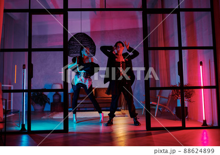 Couple of teenage dancers in posh apparel performing vogue dance movements Couple of teenage dancers in posh apparel performing vogue dance movements 88624899