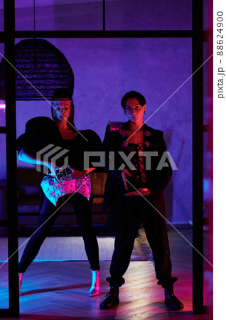 Youthful couple in stage costumes standing by the door of dance studio Youthful couple in stage costumes standing by the door of dance studio 88624900