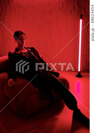 Young restful posh man or teenage guy in smart suit relaxing in armchair in club 88624954
