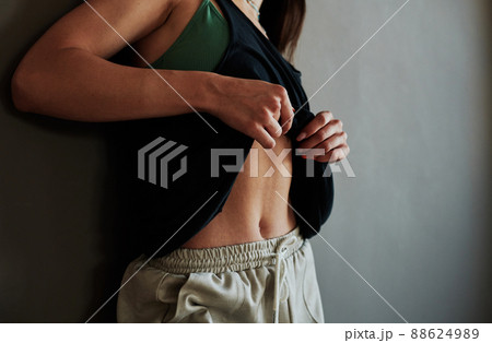 Young contemporary sportswoman or dance performer having rest after training Young contemporary sportswoman or dance performer having rest after training 88624989