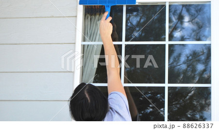 Female beauty washing windows. 88626337