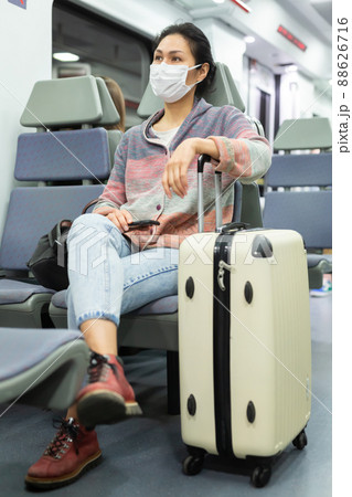 Woman in mask traveling in urban train Woman in mask traveling in urban train 88626716