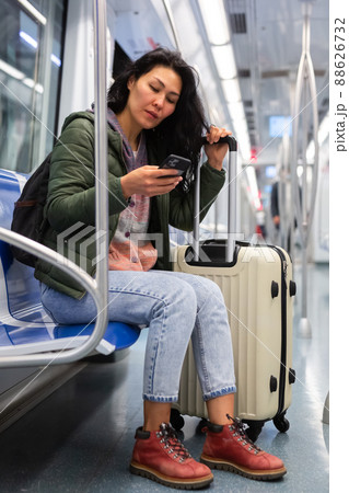 Woman passenger using phone in subway car 88626732