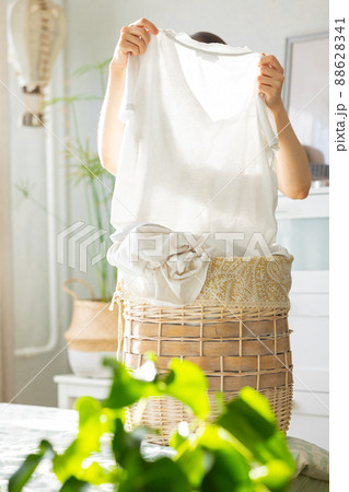 caucasian woman sorting dirty laundry basket, laundry at home caucasian woman sorting dirty laundry basket, laundry at home 88628341