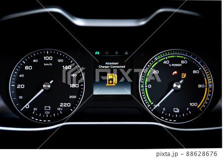 Digital modern dashboard in a electric vehicle - EV while charging at the charging station, battery electric vehicle or BEV. Dashboard in the vehicle showing charging status. Digital modern dashboard in a electric vehicle - EV while charging at the charging station, battery electric vehicle or BEV. Dashboard in the vehicle showing charging status. 88628676