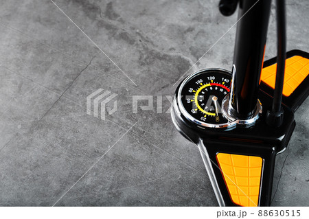 Air pump manometer for monitoring tire pressure on a dark background with free space Air pump manometer for monitoring tire pressure on a dark background with free space 88630515