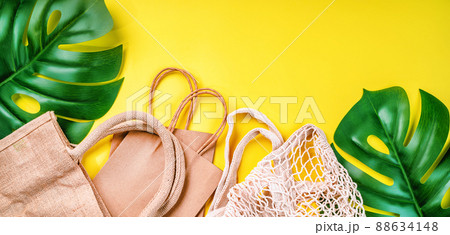Eco Bags.A variety of eco bags on a yellow background . Sustainable lifestyle.Zero waste minimal composition with tring and canvas bags for storage.Zero waste, eco friendly shopping.Top view,flat lay. 88634148