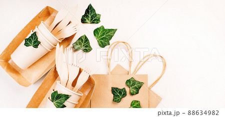 Recycling,eco-friendly concept.Disposable eco cutlery,plates,spoons,knives,forks on a light background.Craft paper bag for food delivery.Copy space.Eco craft paper tableware,cups,fast food containers. Recycling,eco-friendly concept.Disposable eco cutlery,plates,spoons,knives,forks on a light background.Craft paper bag for food delivery.Copy space.Eco craft paper tableware,cups,fast food containers. 88634982