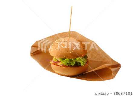Delicious and juicy hamburger in recyclable craft brownpaper Delicious and juicy hamburger in recyclable craft brownpaper 88637101