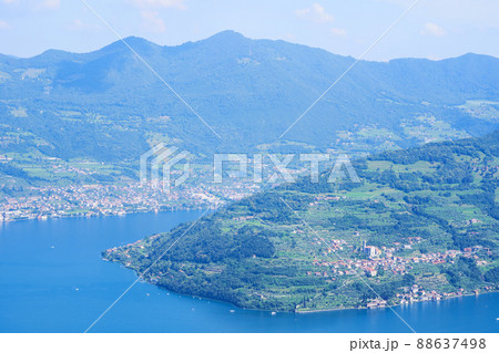 Aerial view of lake Iseo, forested mountains, various villages scattered along the mountain slopes and along the coast. Iseo lake in Brescia province, Lombardy, Italy Aerial view of lake Iseo, forested mountains, various villages scattered along the mountain slopes and along the coast. Iseo lake in Brescia province, Lombardy, Italy 88637498