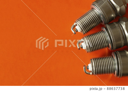 Car spark plug on orange background Car spark plug on orange background 88637738