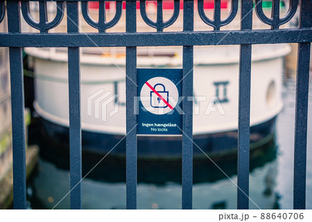 a sign no locks, warning against locks on the handrails of the Nyhavn Bridge. Copenhagen, Denmark a sign no locks, warning against locks on the handrails of the Nyhavn Bridge. Copenhagen, Denmark 88640706