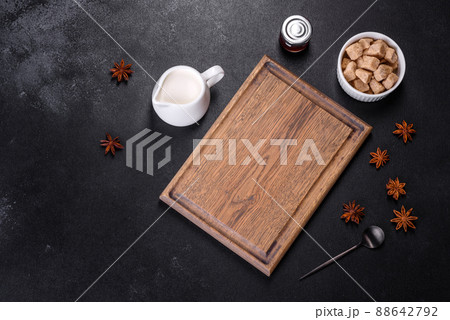 Sugar, cinnamon and other spices on a wooden cutting board 88642792